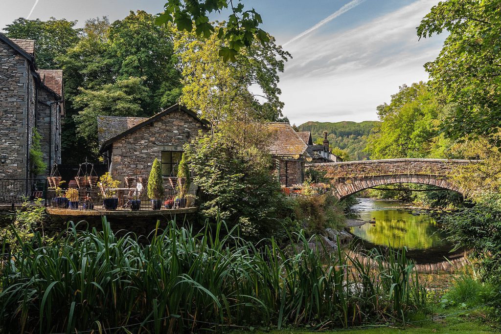 cottage and bridge next to a river